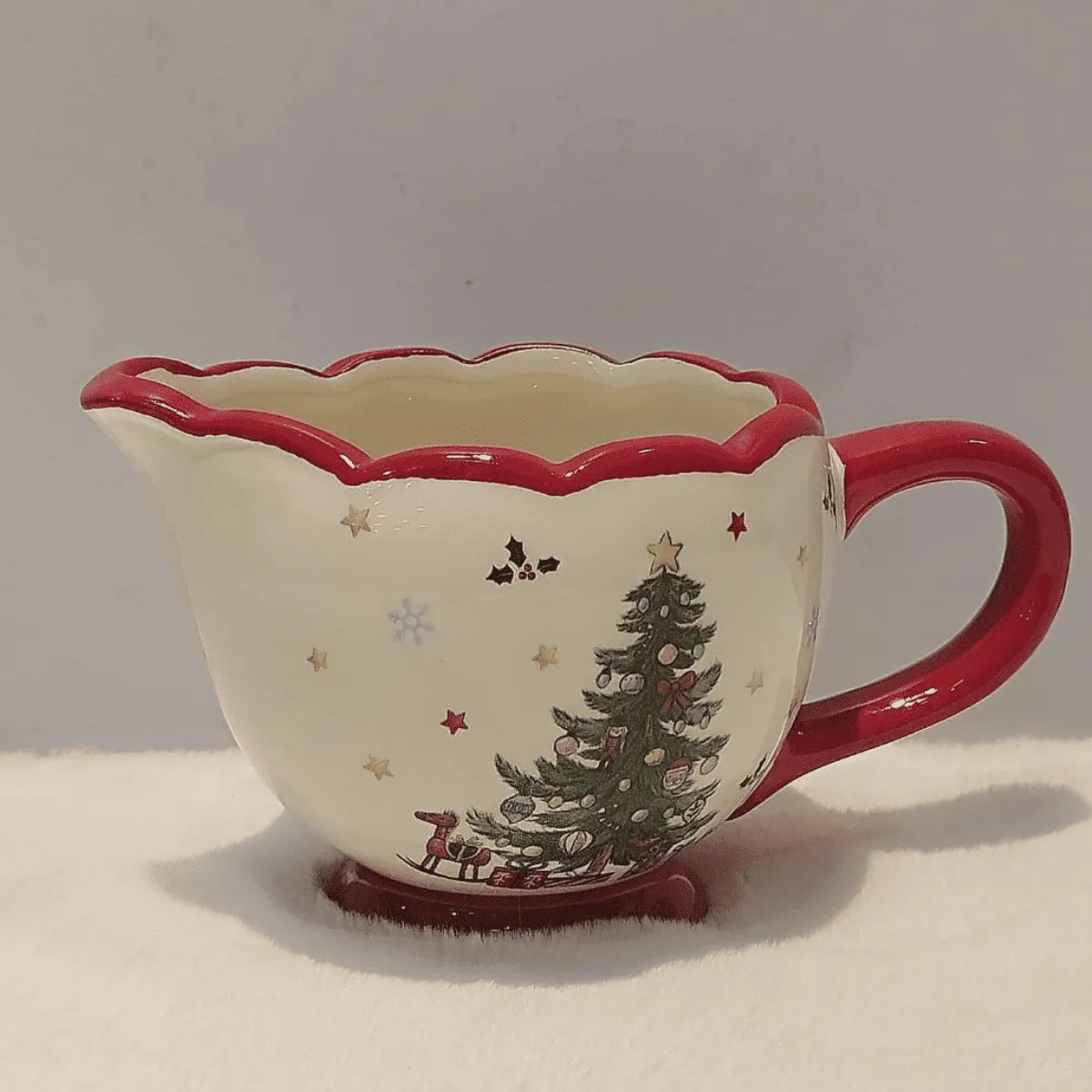 Christmas-themed creamer with festive design.