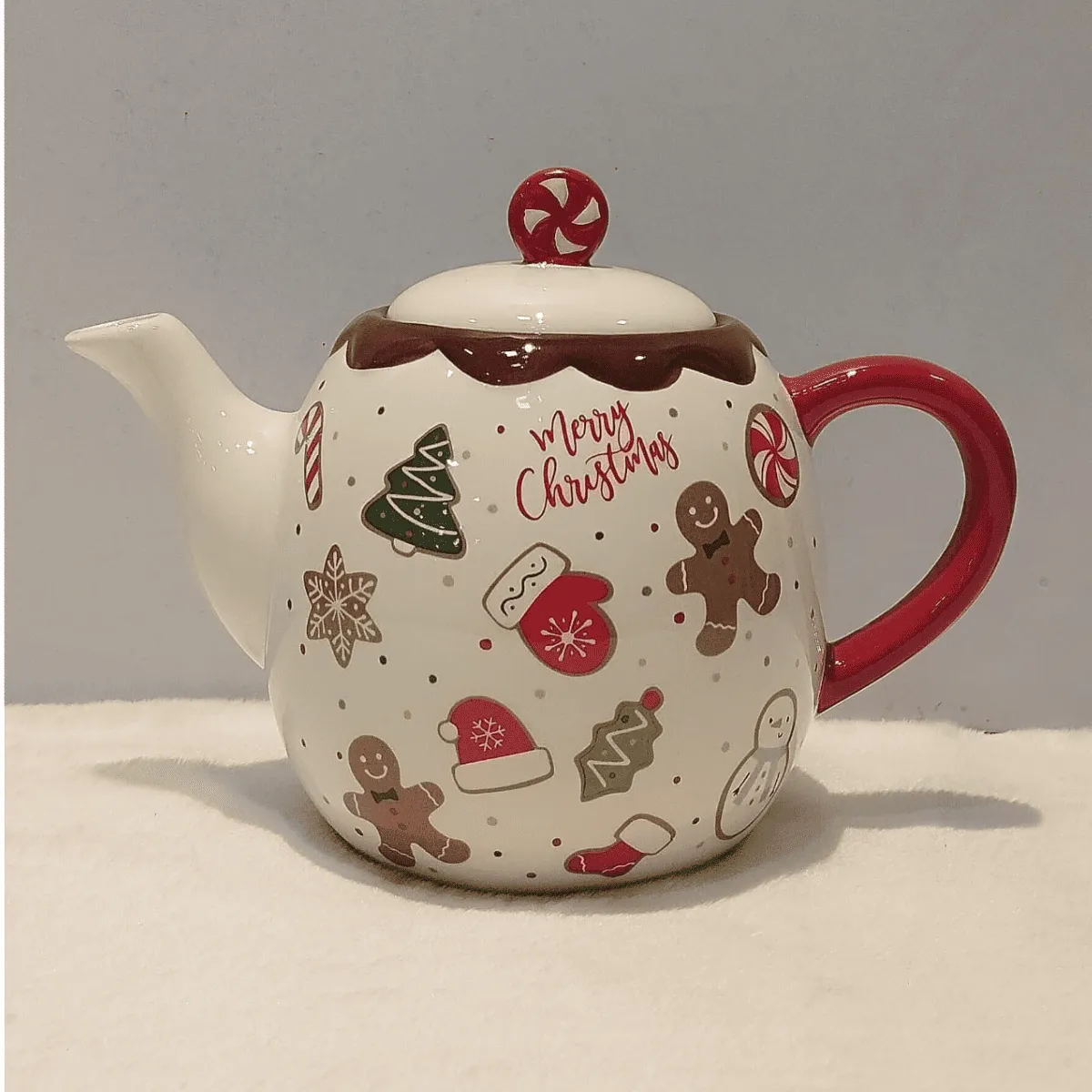 Festive Christmas teapot with playful designs.