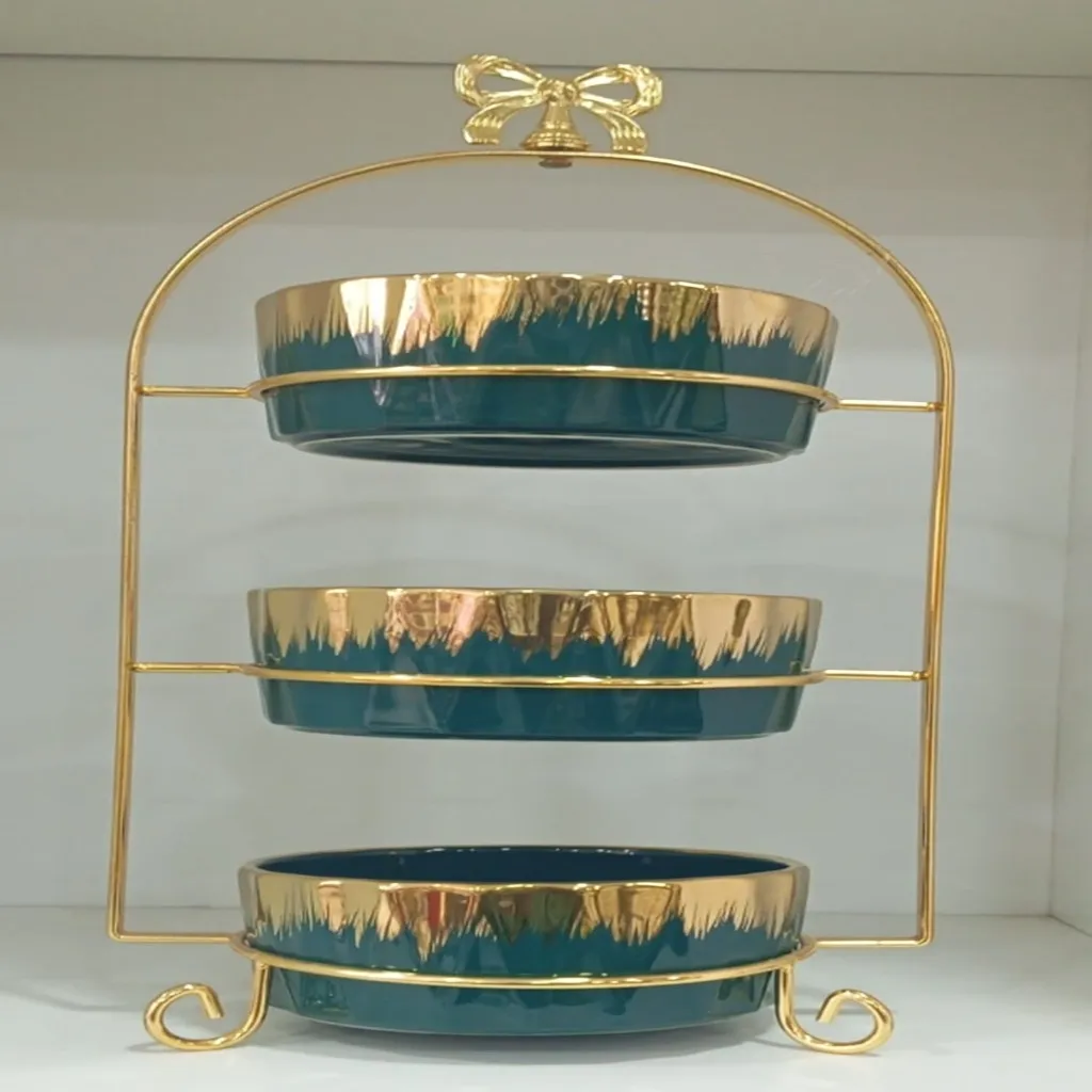 Three-tier ceramic serving stand with a gold metal frame