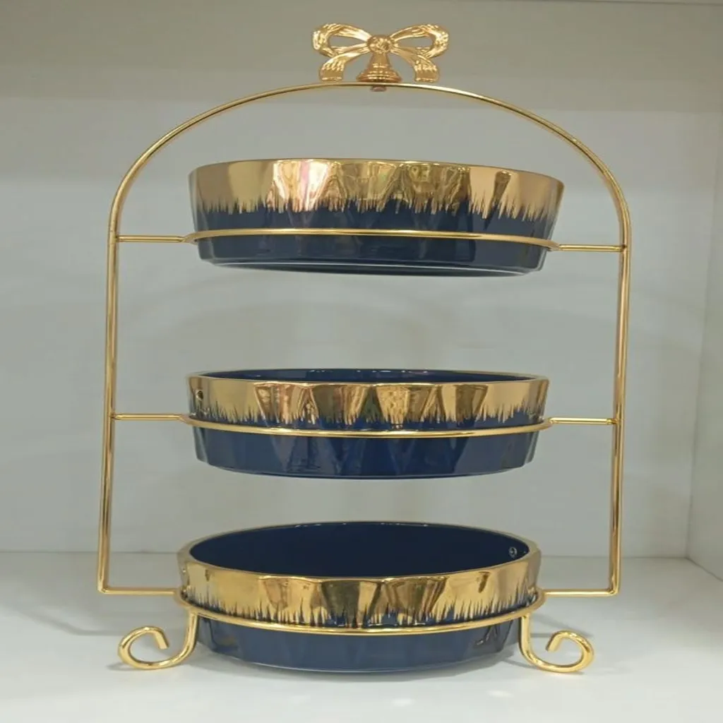 Three-tier ceramic serving stand with a gold metal frame (image 2 of 2)